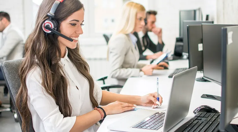 Customer service rep taking notes on a call