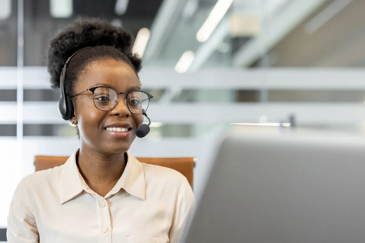 Smiling customer service rep using a CRM system